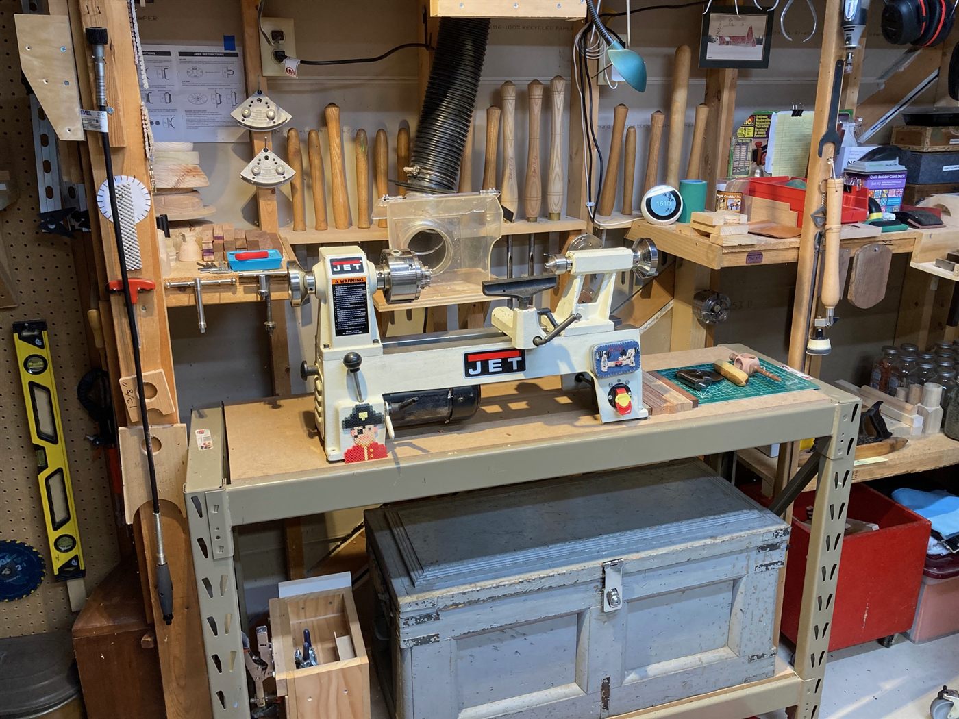 The lathe in the workshop, with turning tools racked behind it