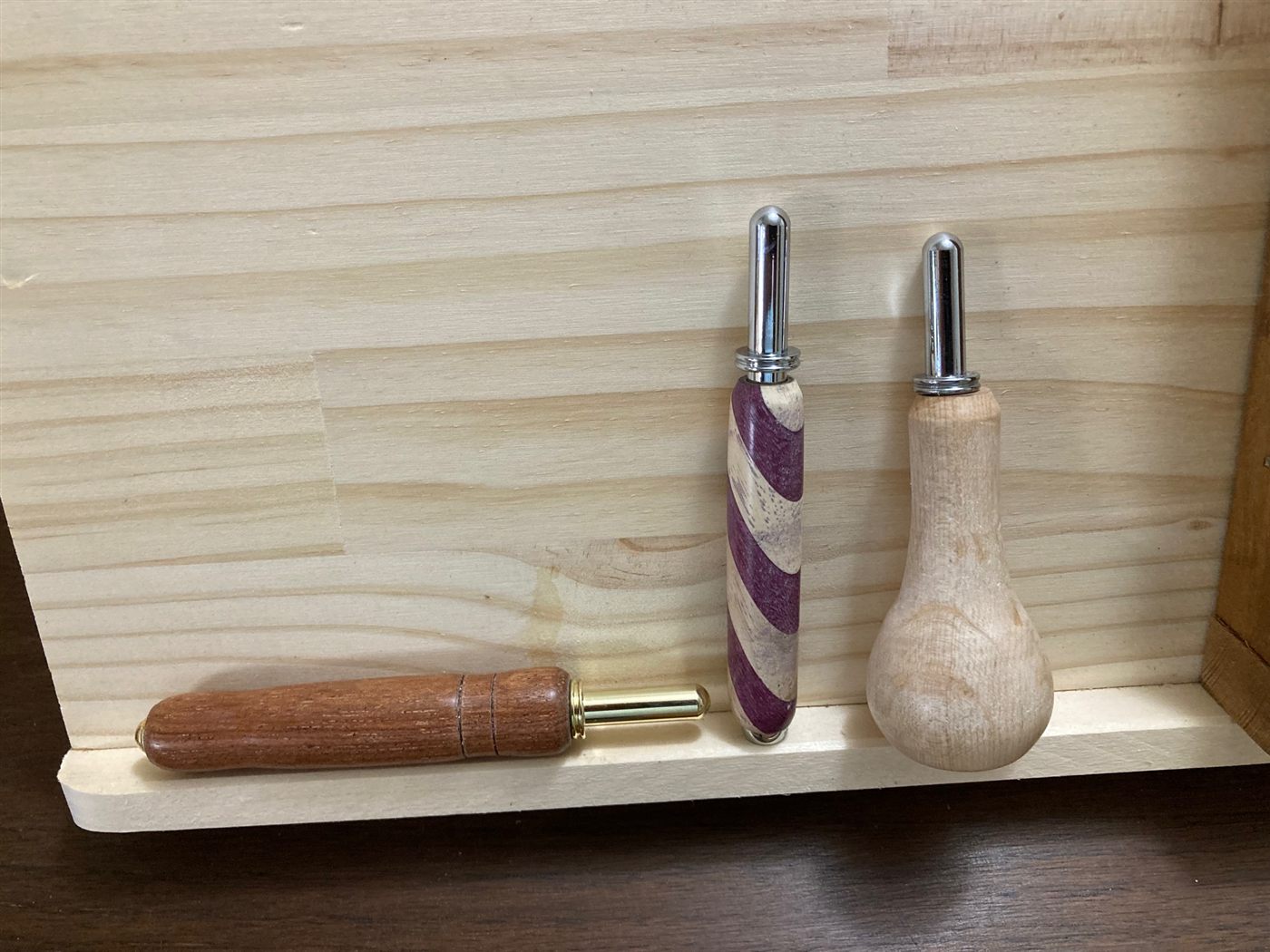 Three seam rippers with different turned handles